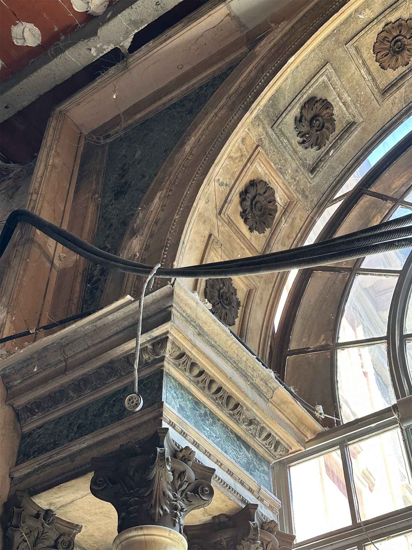 Vista dal basso dell'arcata e dei capitelli della serliana durante il cantiere